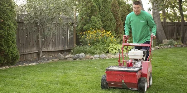 technician overseeding lawn